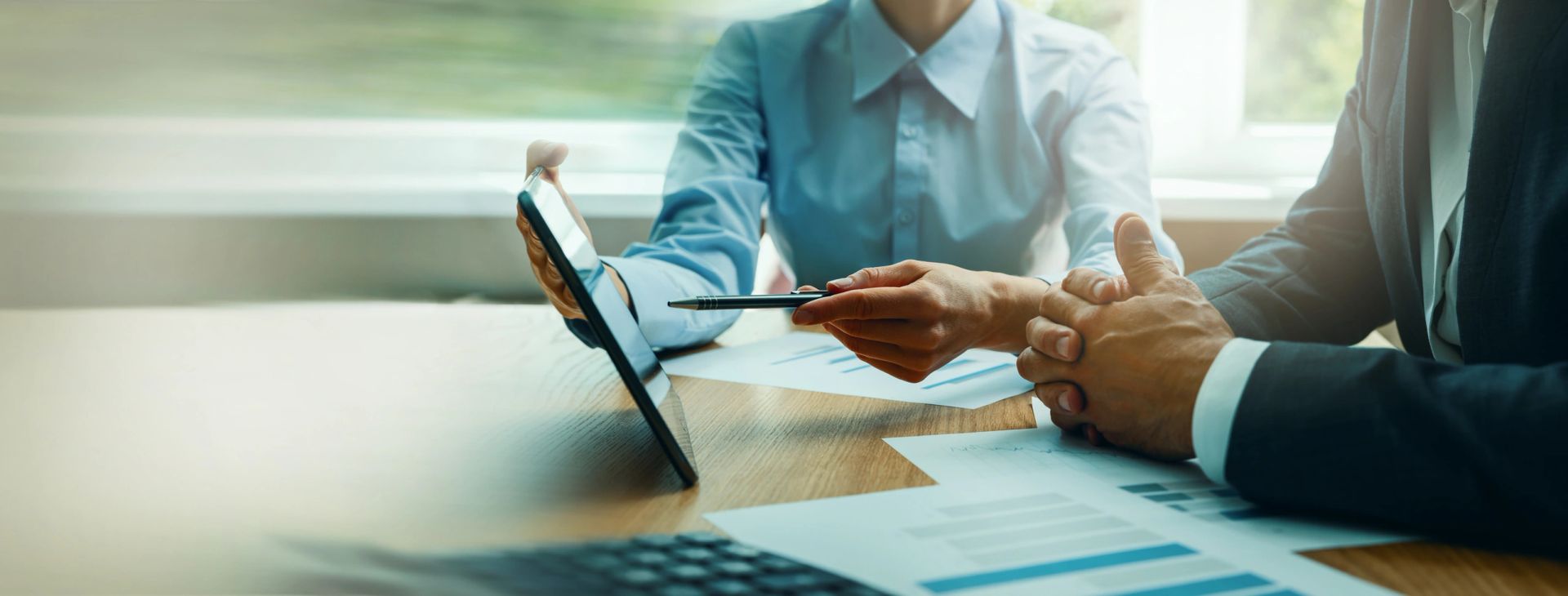 business consulting services. advisor and businessman working at desk in office. corporate strategy with digital tablet