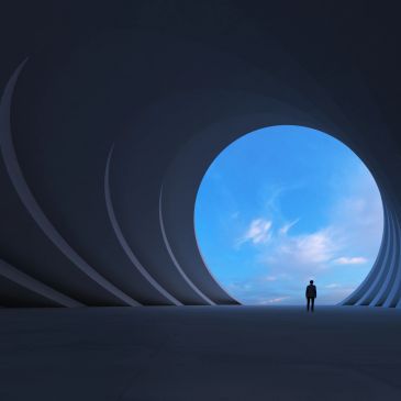 Amplified - Man walking through a large exit in a modern building towards the light at the end of the tunnel